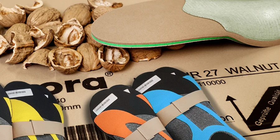 Des semelles posées sur une plaque de matériau Nora avec des coquilles de noix